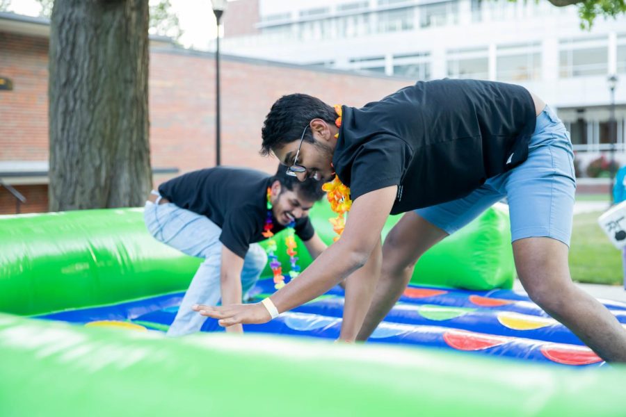 Grad students Kunal Durge and Shashidhar Reddy Donthireddy plays inflatable twister at the beach party. The event was hosted by SAC at RSCs east courtyard on Aug 25.