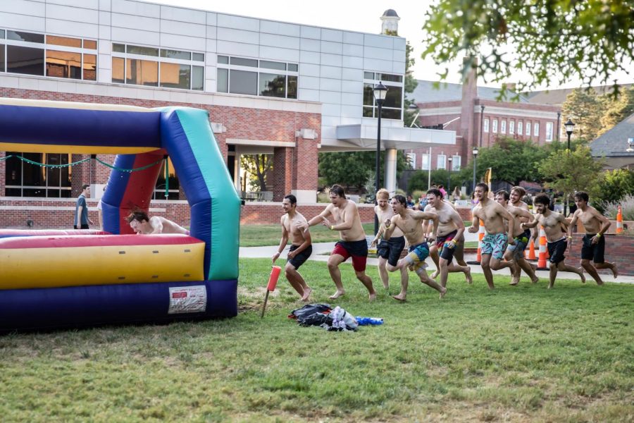 WSU students rush to go through the giant slip-n-slide at the Beach Party on Aug 25. The event was hosted by SAC at RSCs east courtyard with music, sno-kones and outdoor activities.