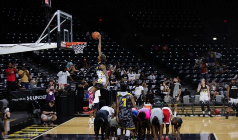 YouTube street baller One Foot God from Team Garland, jumps over a group of kids on his final dunk. He won the dunk contest by two points on Aug. 13 in Charles Koch Arena.  