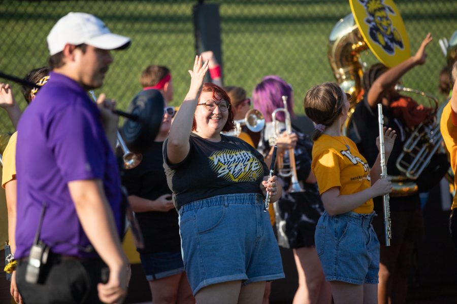 Members of the Wichita State band wave at the Wind Surge crowd on college night on Aug. 18.