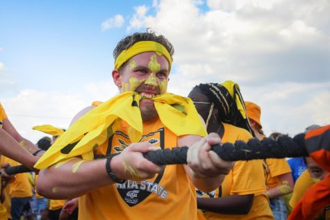 Freshman Conner Murphy, College of Liberal Arts and Sciences competes against the College of Fine Arts in a game of Tug-of-War.