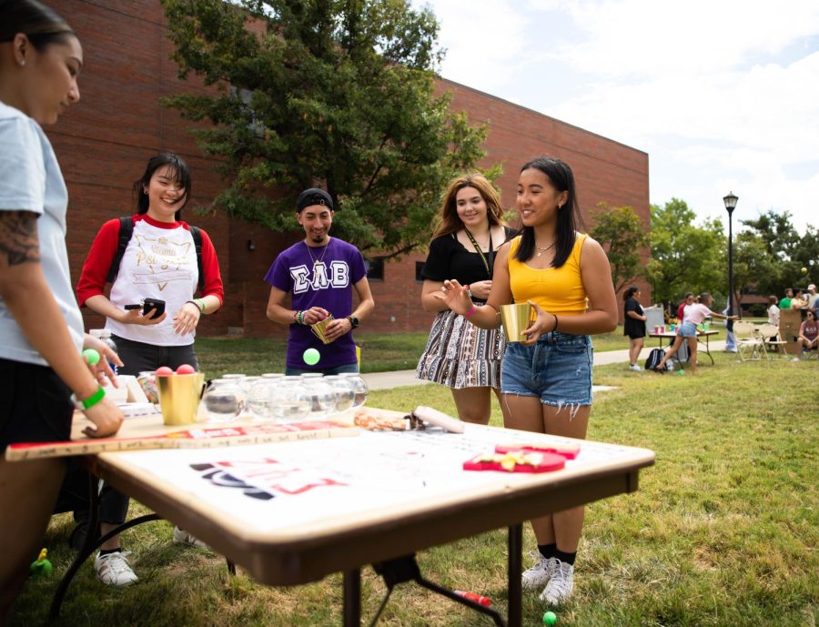 Freshman Amy Nguyen throws a ball into the fishbowl at the Greek Carnival on Aug. 27.