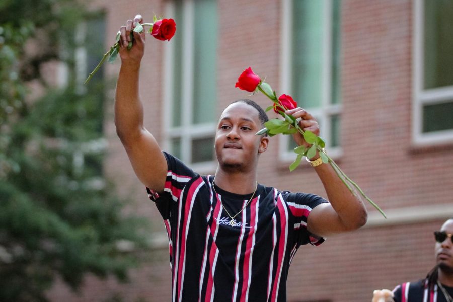 Elijah Kelly of Kappa Alpha Psi Fraternity Inc. hands out roses to the audience. The first annual NPHC Yard Show was held on Aug. 29, 2022.