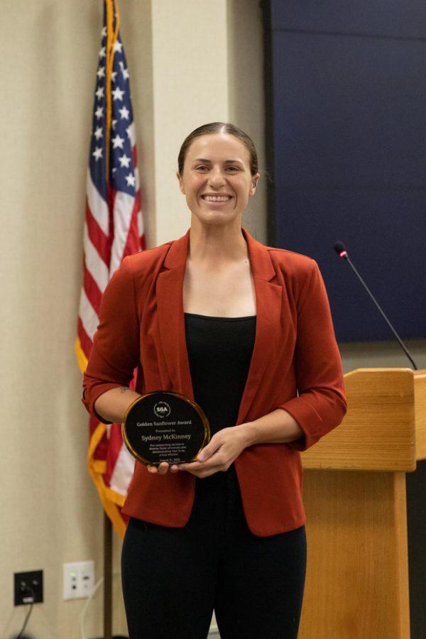 After receiving The Golden Sunflower award at the SGA meeting on Aug. 31, softball player Sydney McKinney poses for a photo.