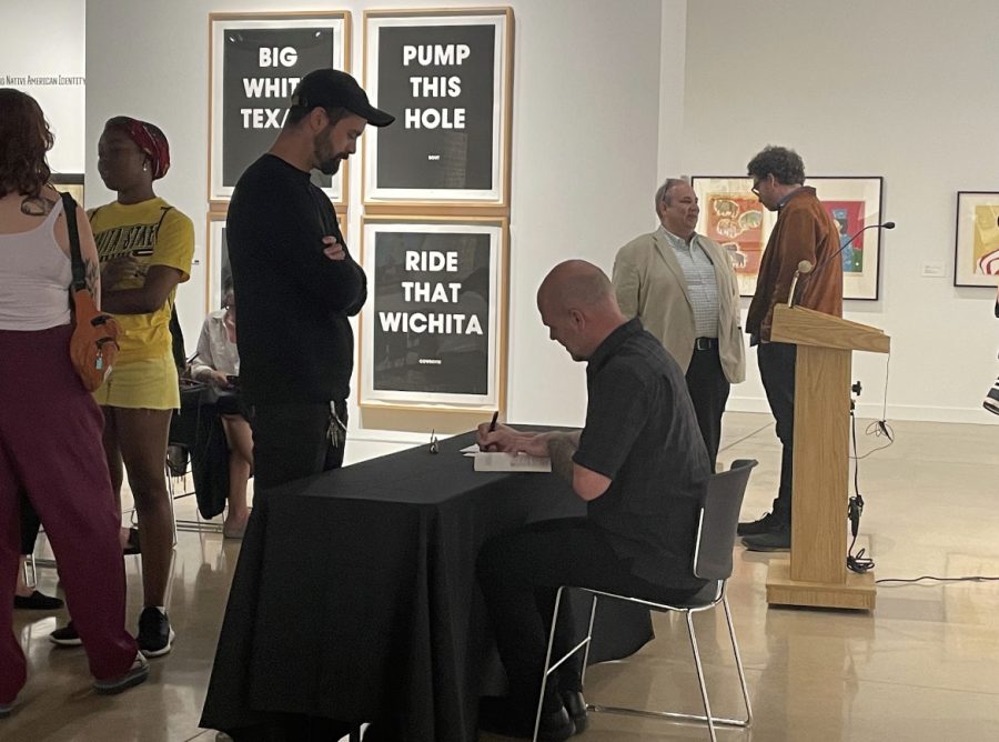 Author Jason Allen signs a book for an attendee at Writing Now, Reading Now at the Ulrich Museum of Art on Sept. 14.