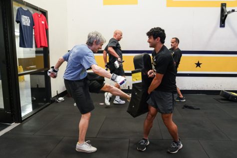 Elizabeth Behrman is a professor of Quantum Information Theory. Behrman  kicks a punching bag during F45 Training on Sept. 9, 2022 at the Heskett Center.