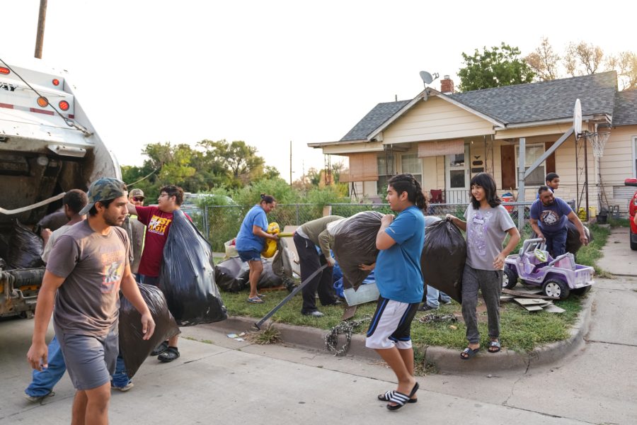 A neighborhood family comes out to help the Shocker Neighborhood Coalition to clear debris and litter in the neighborhoods around campus during the Community Service Board on Sept. 10.