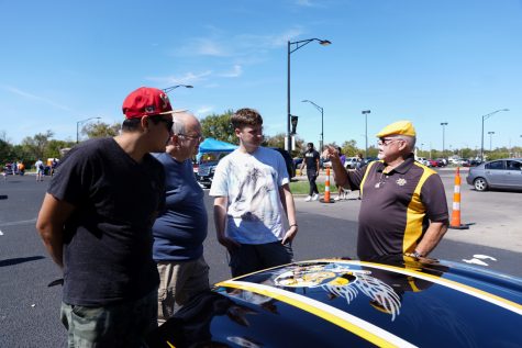People discusses about the car at Show N’ Shine car show in parking Lot 1 between Hillside Avenue and the Duerksen Fine Arts Center on Sunday, Sept. 25.
