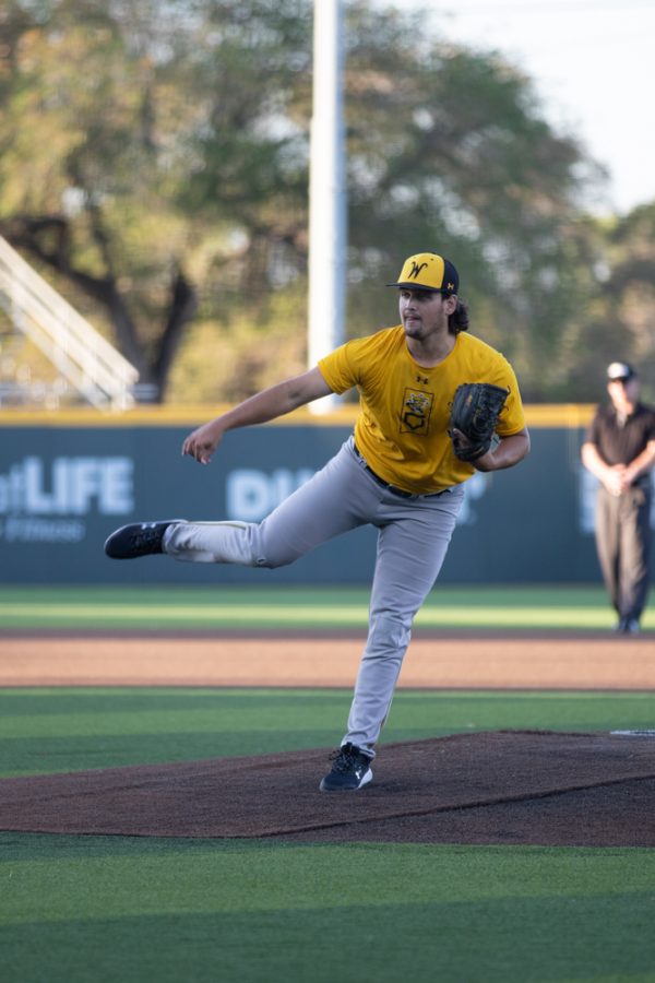 Junior Nate Adler throws a fastball against the Mississauga Tigers on Sept. 26 in Eck Stadium. The Shockers defeated the Tigers 22-2 to claim their second straight victory.