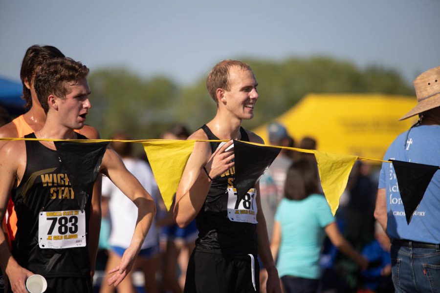 Junior Jackson Caldwell cheers on his competitors during the JK Golden Classic on Sept. 3 in Augusta. Caldwell finished fourth place with a time of 18:30.5.
