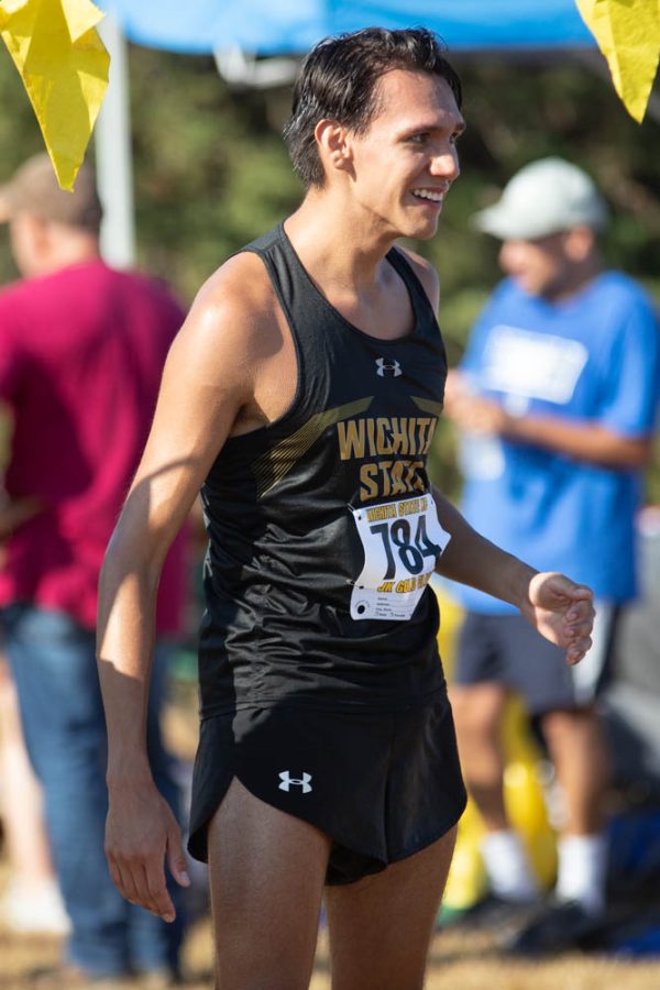 Sophomore Erik Enriquez cheers on his teammates during the JK Golden Classic on Sept. 3 in Augusta. Enriquez finished with a time of 18:41.0 and took sixth place.