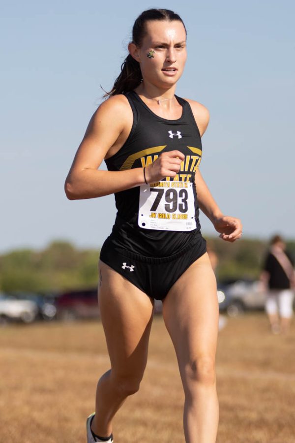 Sophomore Miranda Dick flashes through the 5 Kilometer race at the JK Golden Classic on Sept. 3. Dick took third place with at time of 19:04.7.