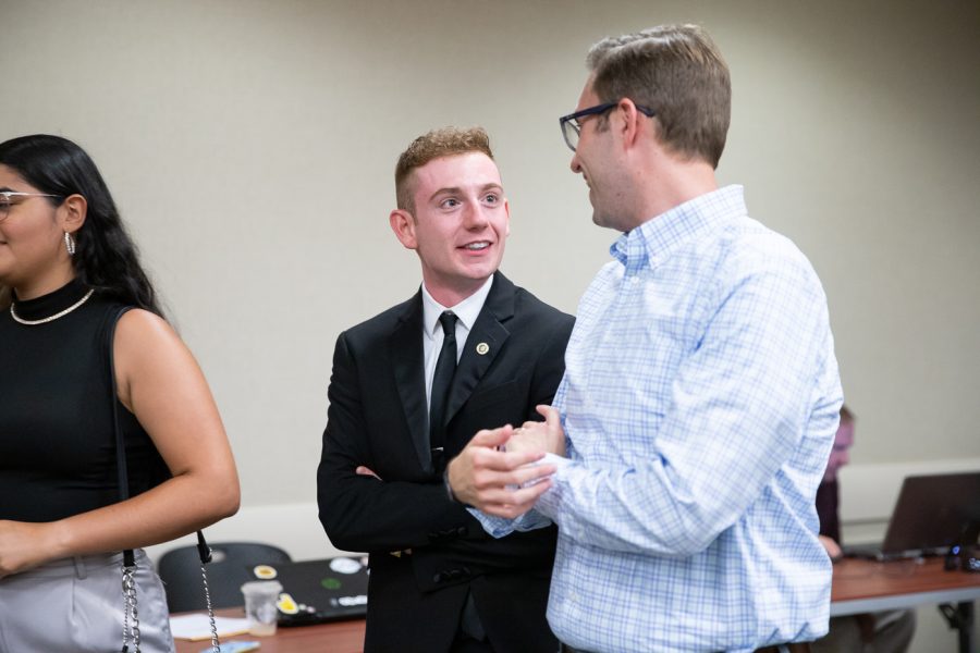 At-large senator Hunter Minette speaks to an attendee at The State of the Student Body on Sept. 7. The event was hosted by SGA.