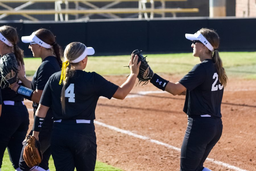 Zoe Jones and Taylor Sedlacek gives highfive to eachother during WSU’s game against Seminole State on Sept. 27 at Wilkins Stadium.