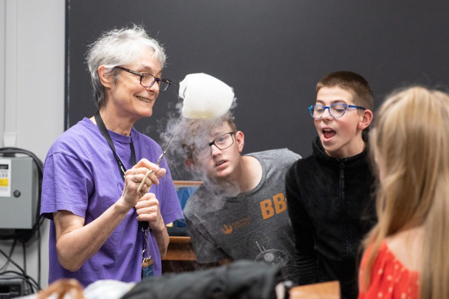 Professor Elizabeth Behrman demonstrates what happens when you pour liquid nitrogen on a balloon to K-12 students involved in Math Circle. Math Circle was a group that met up on Sundays to help instill the love of math and math-related subjects in younger generations.