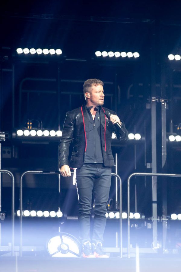 Brian Littrell greets his Wichita fandom with during his opening song Everyone on Sep. 13. Littrell and the band members showed off their 90s dance moves, in Intrust Bank Arena, to get the crowd pumped for the rest of the show.