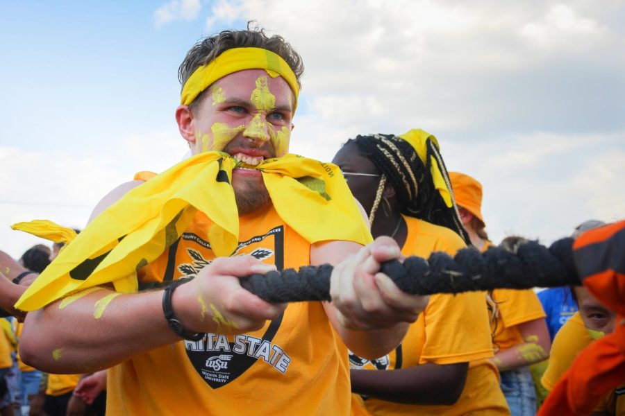 Freshman Conner Murphy, a student from the College of Liberal Arts and Sciences competes against the College of Fine Arts in a game of Tug-of-War. The annual competition was held on Aug. 26, 2022, at Cessna Stadium.