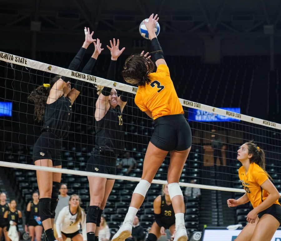 Redshirt junior Brylee Kelly goes up to spike the ball during the match against UCF on Oct. 2 at Charles Koch Arena.