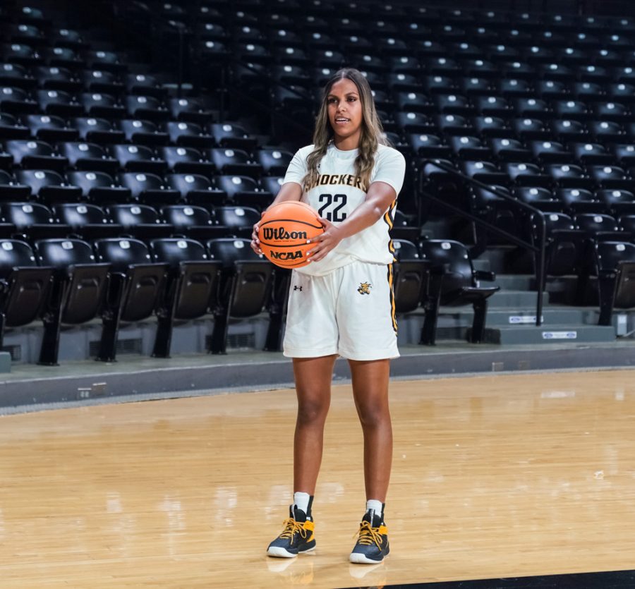 Womens Basketball team player Ambah Kowcun poses for a photo with the ball at Charles Koch Arena on Oct. 18.