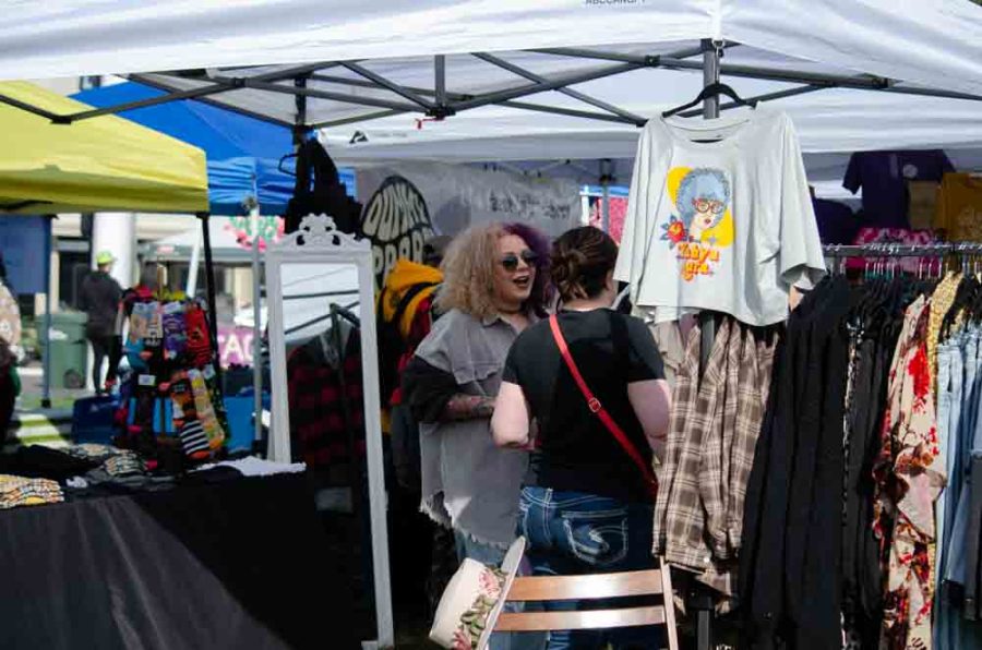 Local vendor chats with shopper. On Sunday, local businesses gathered at Naftzger Park for the Shop and Grub Event.