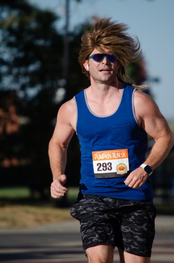 Pumpkin Run contestant rocks the mullet while finishing the race. During Saturday’s Pumpkin Race, a 5k runner wore a wig while participating in the event.