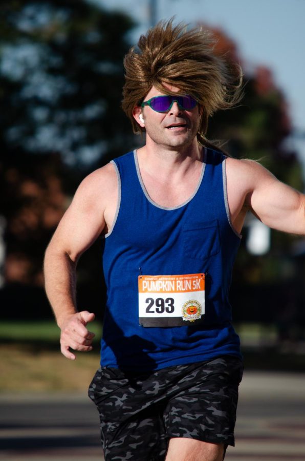  Pumpkin Run contestant rocks the mullet while finishing the race. During Saturday’s Pumpkin Race, a 5k runner wore a wig while participating in the event.