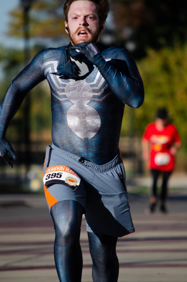  Pumpkin Run 5k contestant donns a Venom costume as he finishes the race. On Oct 22, people crowded Wichita State to attend the annual Pumpkin Run event.