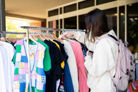 Josie Millers browses the clothing rack at the Dead Center Vintage Pop up event. The shop set up outside the Rhatigan Student Center on Oct. 20.