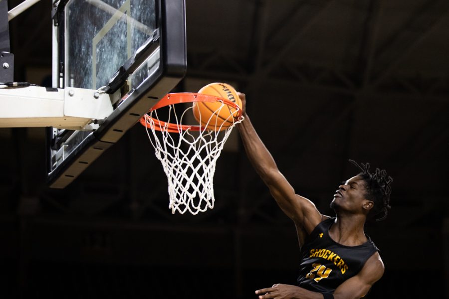 Redshirt-Freshman Isaac Abidde makes a slam dunk during the first portion of the Dunk Contest on Oct. 27 in Charles Koch Arena.