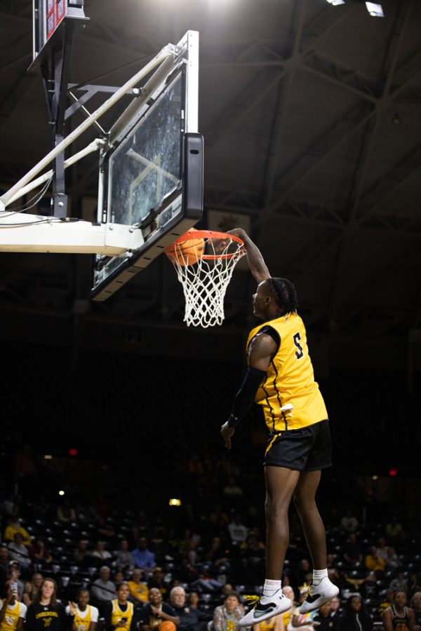 Sophomore Jaron Pierre Jr. makes a slam dunk during the Dunk Contest on Oct. 27 during Shocker Madness.