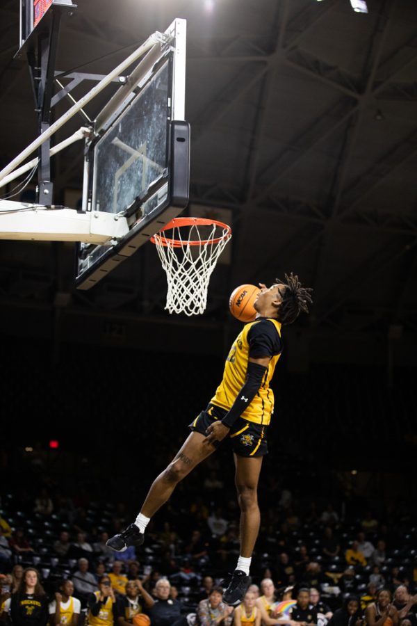 Sophomore Shammah Scott puts up his final dunk of the night during the Dunk Contest on Oct. 27 in Charles Koch Arena. Scott was named the 2022-23 Dunk Contest Champion.