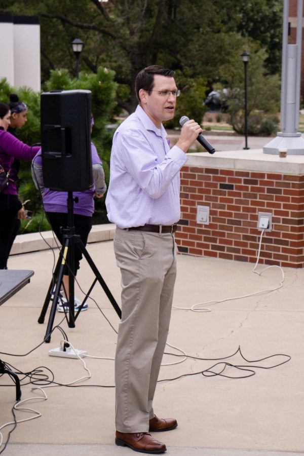 Sedgwick County District Attorney Joshua Steward addresses Purple Mile participants with messages of hope, resilience, and gratitude for Wichitas domestic violence prevention and care services. Steward then led participants to the Plaza of Heriones, where a moment of silence was given to honor victims and survivors of domestic violence.