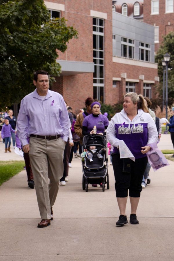 Sedgwick County District Attorney Joshua Steward leads Purple Mile participants to the Plaza of Heroine for a moment of silence to honor those who have suffered, or continue to suffer from domestic violence. Over 100 domestic violence survivors, their families and advocates participated in the annual march which aims to raise awareness for Domestic Violence Awareness Month.