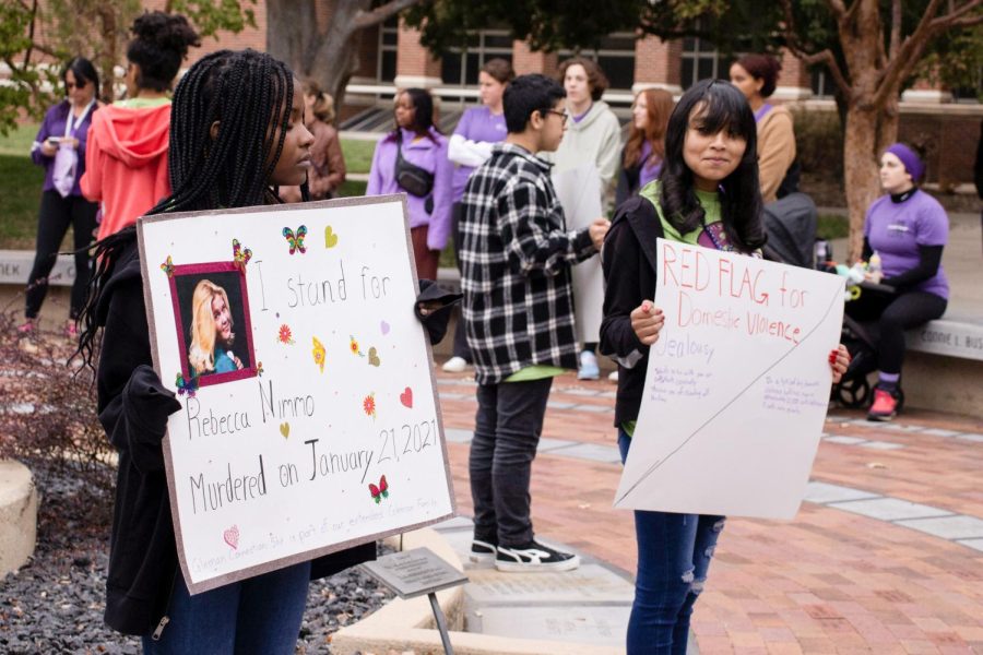 Worldbuilders volunteers hold signs that share domestic violence resources and red flags, as well as signs that honor deceased victims of domestic violence. The Worldbuilders then helped lead the mile long march around campus before returning to the RSC.