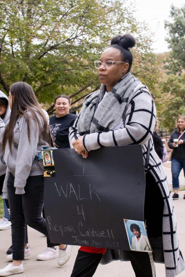 Meagan Young marches silently during the Purple Mile in honor of her friend Reyona Caldwell, who passed during a house fire with suspicious circumstances. Young was joined by Caldwells family members who, since Reyonas death, have become active in domestic violence advocacy work.