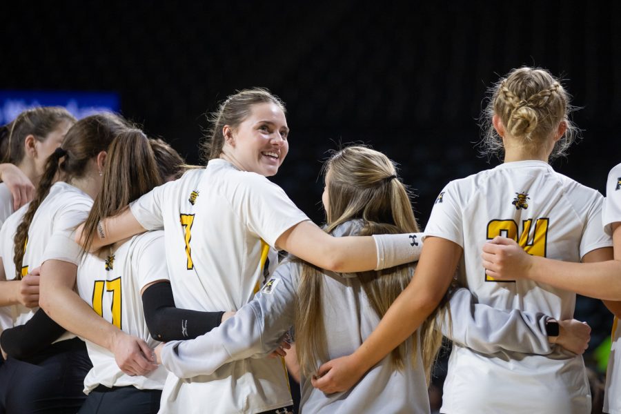 Redshirt freshman Addy Badley holds her teammates before the match against the South Florida Bulls begins on Oct. 28. The Shockers won 3-0.