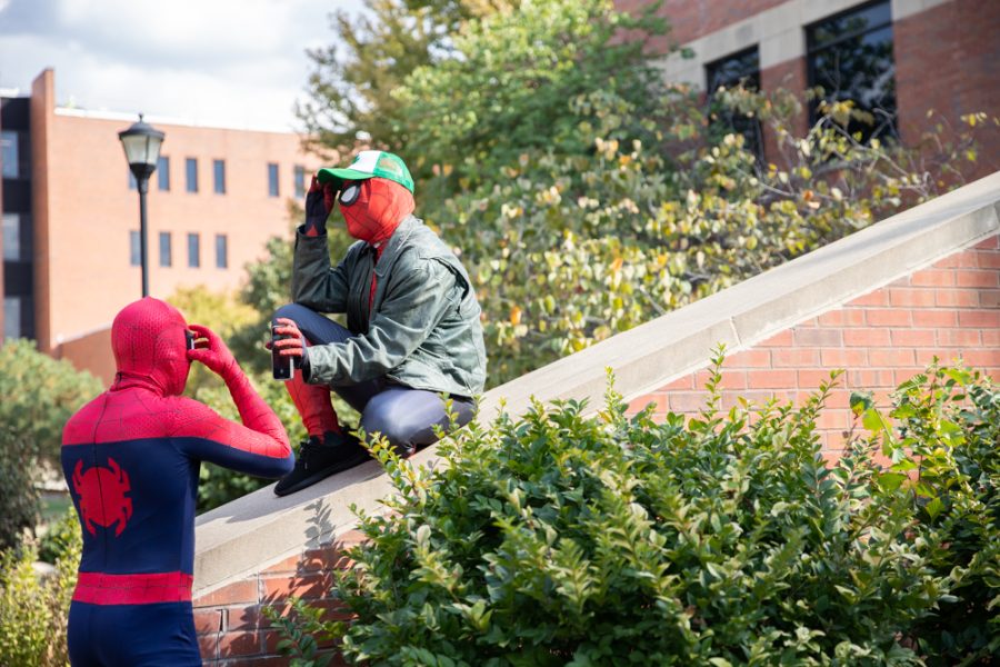 Nicholas Davis holds a camera as sophomore Alejandro Claiver adjusts his mask on Oct. 10 outside of Elliott Hall. Davis called Claiver his ‘Uncle Ben’ after becoming a WSU superhero.