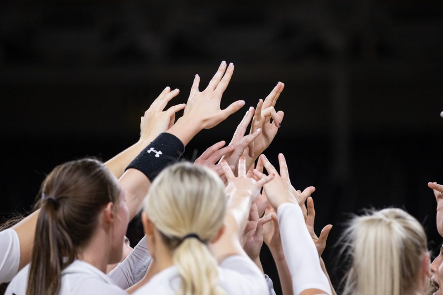 The Wichita State volleyball team raise their hands after defeating the South Florida Bulls, 3-0. The match took place on Oct. 28 inside Koch Arena.
