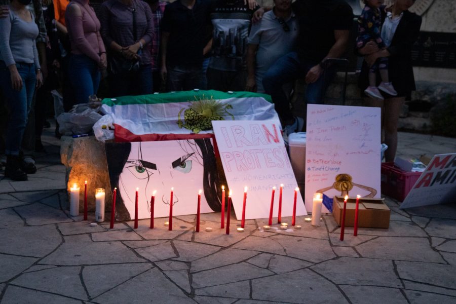 Candles light up the artwork presented at the vigil for Iranian women killed on September 30, 2022. After a speech was given, the candles were lit, and a picture was taken of the group who attended.