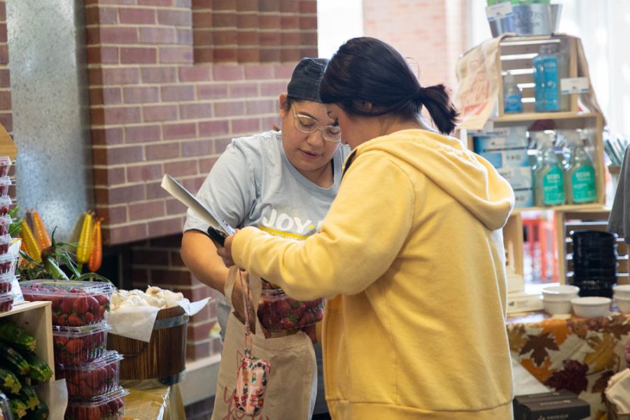 Pre-dental hygeine major Dama Sanchez buys fruit at the Farmers Market from Andrea Servin on Oct. 6. Students attended the Joyful Fall Festival held in Shocker Dining Hall. 