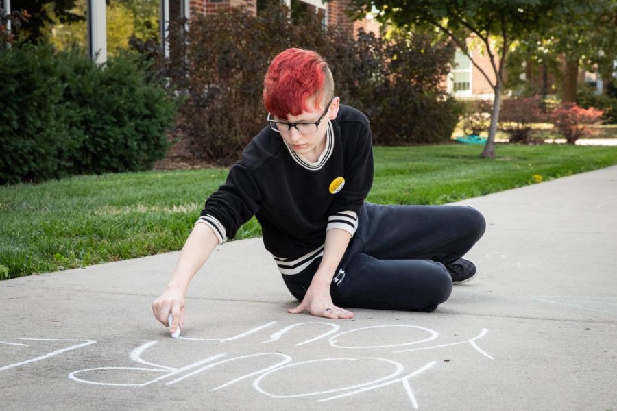 Rowan Singer writes messages advocating for abortion rights on the sidewalks of the RSC North patio. Members of FOCUS (Feminists On Campus Uniting Students) and CatCallsOfICT mentioned that there were students who walked past and told them other topics to write about as well.