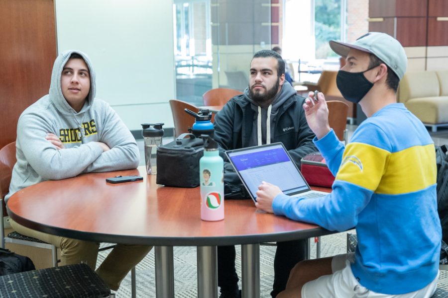 Ryan Flores, Zeeshan Azmi and Bader Altohol speak with Officer Zachary Hendrich inside the RSC on Oct. 19. In return for having a conversation, the group recieved Police Reward Tokens designed as poker chips.