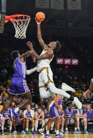 Sophomore forward Quincy Ballard dunks the ball during the game against Central Arkansas at Charles Koch Arena on Nov. 7.