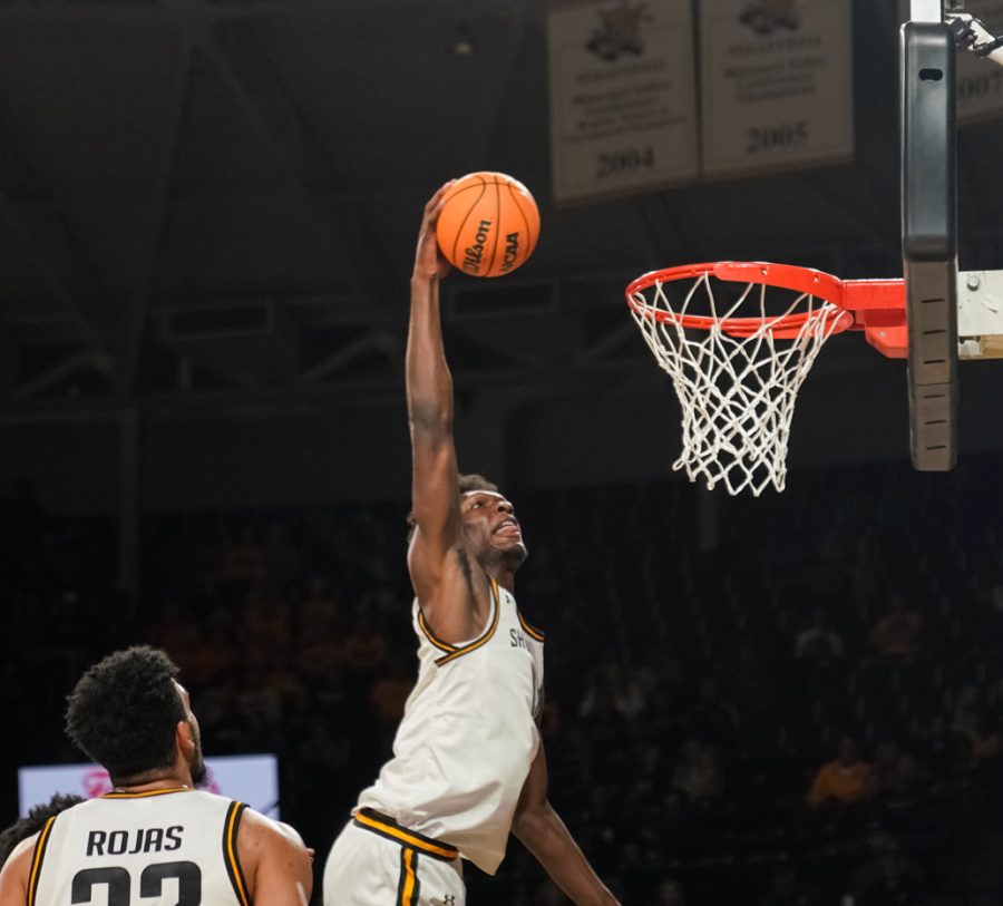 Sophomore Quincy Ballard dunks the ball during the game against Central Arkansas at Charles Koch Arena on Nov. 7.