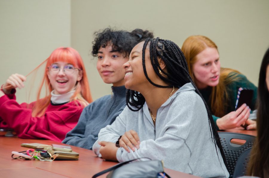 Ayshea Banes (right) laughs during a conversation during the first Shockers (Taylors Version) meeting. On Nov 16, Banes participated in discussions between club members.