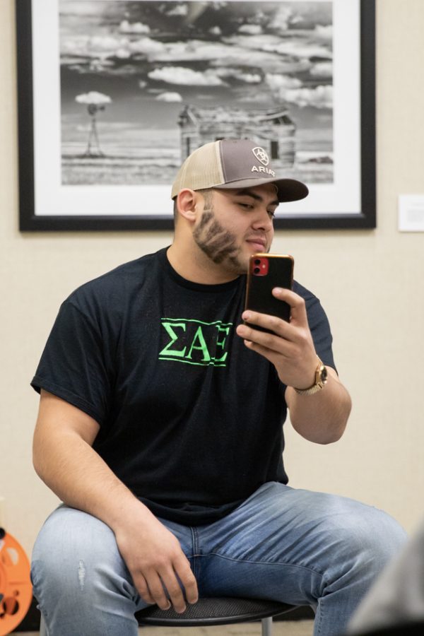 Carlos Martinez,  Sigma Alpha Epsilon member, looks at his beard after auctioning it off.