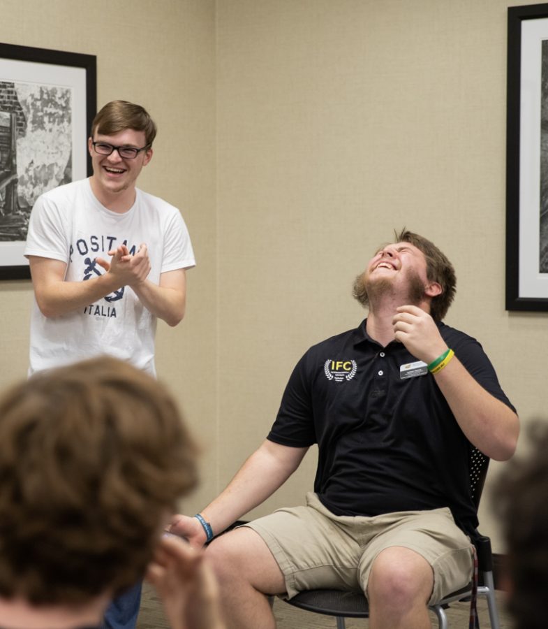 Logan Hutchens, computer science major, laughs with Jackson Ozanne, vice president of administration in the Interfraternity Council. Hutchens shaved Ozannes beard after being the highest bidder at the Interfraternity Council Beard Auction.