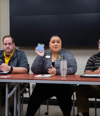 Alicia Newell explains the use of the Rave Guardian app to a student who asked about how to best report crime or concerns on campus. The app was designed to provide users with extra security through features like the “safety timer”, “Call 9-1-1” and “Call WSU University Police.”