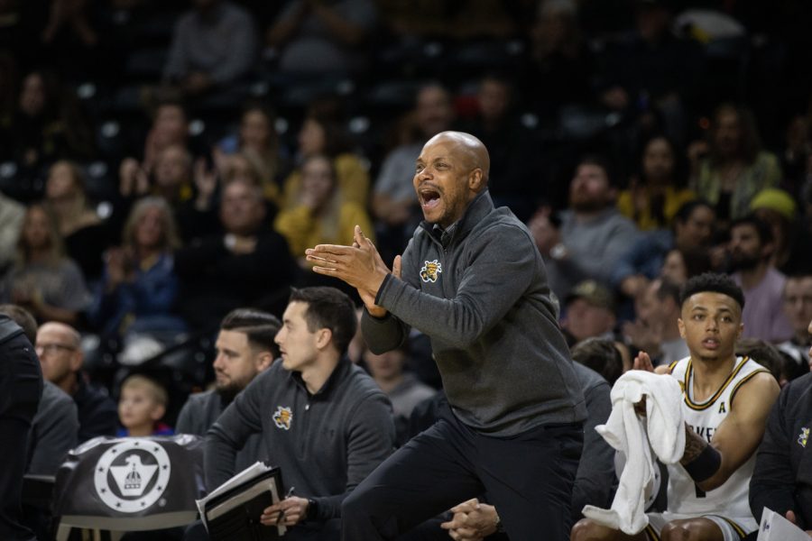 Head coach Isaac Brown claps for the Shockers after a sucessful shot by sophomore forward Kenny Pohto on Nov. 26. The Shockers played the Tarleton State Texans and won, 83-71.