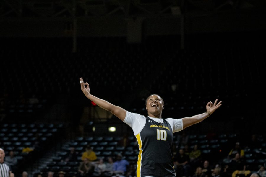 Senior Curtessia Dean celebrates a 3-point shot made by her teammate during Shocker Madness on Oct. 27 in Charles Koch Arena.